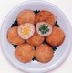 Khanom krok is a coconut pudding snack found at street stalls in Thailand. They are cooked in a pan over a charcoal fire.